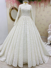 White lace wedding dress on a mannequin with a decorative background