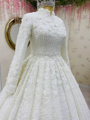 White lace wedding dress on a mannequin with a floral background